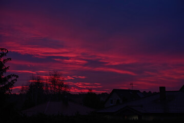 red sunrise over country houses