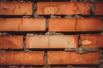 Brown and red brick with cement against the background of the wall. Modern construction. Old...