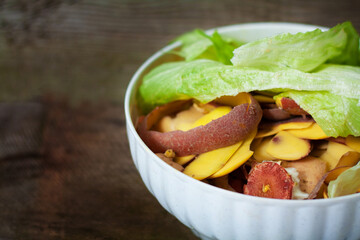 Container of domestic organic food waste ready to be composting on stylish wooden background. Lets...