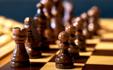 Black pieces on the chess board in the basic position at the beginning of a game, selective focus...