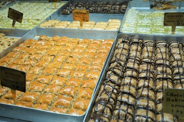 Beautiful colorful Turkish sweets in lamps in the gift shop, Grand Bazaar / Kapalıçarşı, Istanbul, Turkey, Shopping mall or market. A lot of sweets on the counter of the store. 