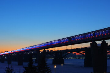 two bridges across the ob river in winter in Novosibirsk at sunset