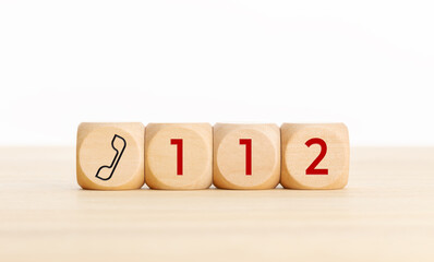 112 emergency concept. Wooden dices with phone icon and 112 text - obrazy, fototapety, plakaty
