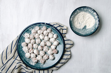 Flour dumplings and flour on a plate