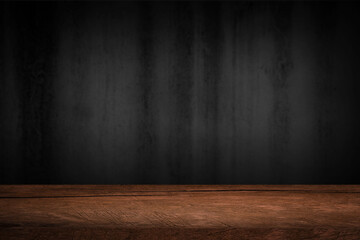 Free space on a wooden table for displaying products with a blurred black wall background.
