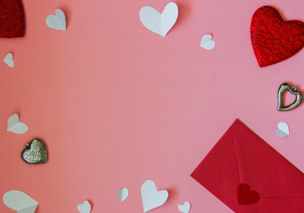 Red envelope, red and white hearts on a pink background. Copy space. Festive background. Background for design. Top view
