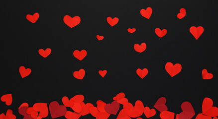 Many little red hearts on a black background. Background for decor.