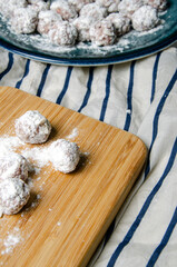 Round patties dipped in flour on a cutting board