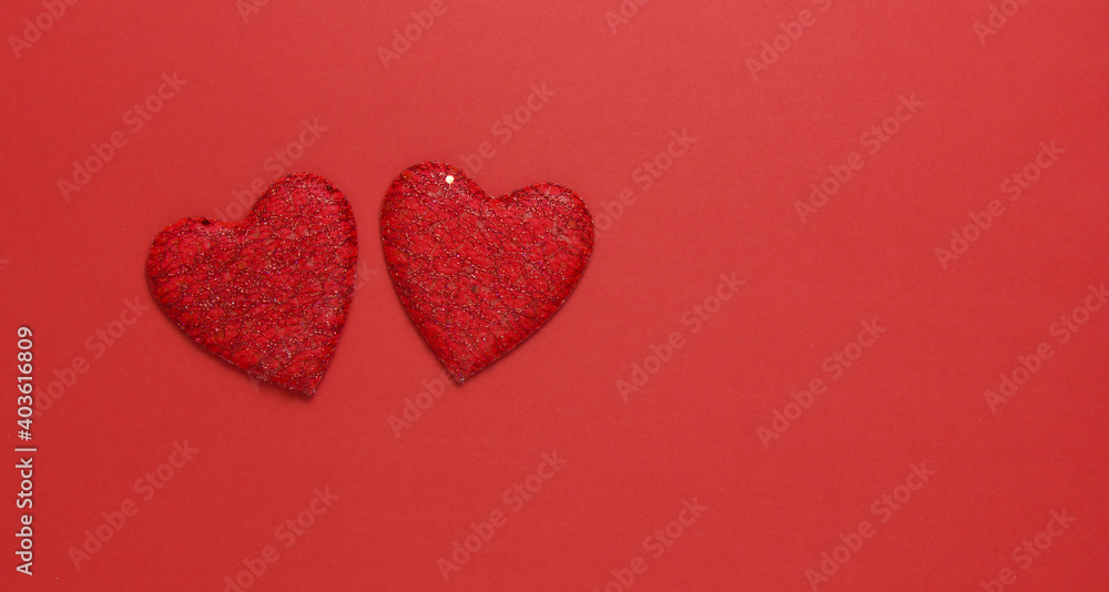 Poster two red hearts on a red background. copy space. festive background. background for design.top view