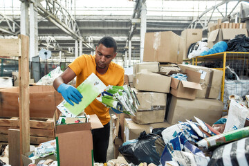 African american man folding packaging waste paper