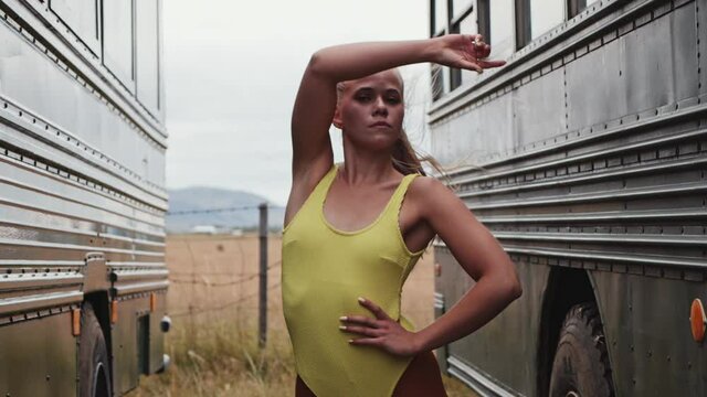 Dancer Posing And Moving To Camera In Between Busses
