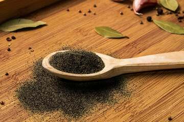 Ground black pepper with a wooden inscription 
