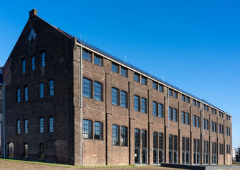Dark brick facade of an old abandoned factory.