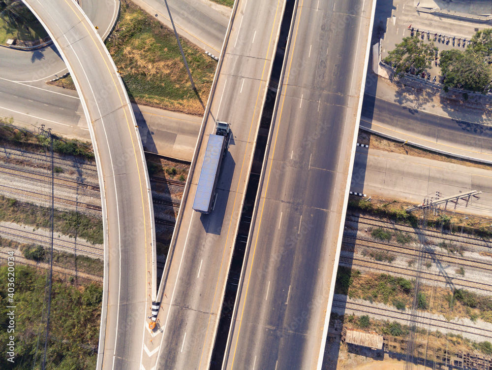 Wall mural Aerial view of cargo Truck on highway road with blue container, transportation concept.,import,export logistic industrial Transporting Land transport on the asphalt expressway