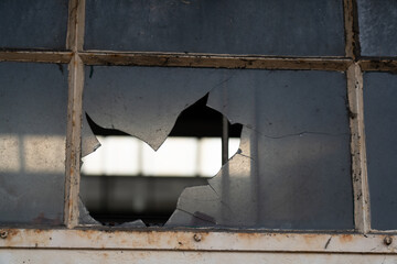 Broken glass window in the Facade of an old factory