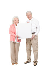 An old senior couple holding white board 