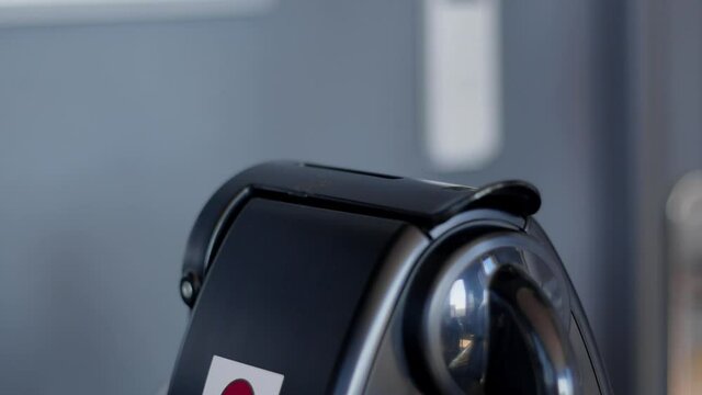 A hand pushing a compostable specialty coffee capsule in an automated espresso coffee machine. Office morning. Nespresso Black coffee maker. High quality still video 4k footage.