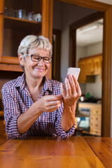 Senior woman using phone. Social distancing, stay at home, lockdown.