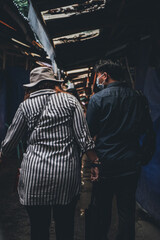 Fototapeta na wymiar Two people strolling in a market