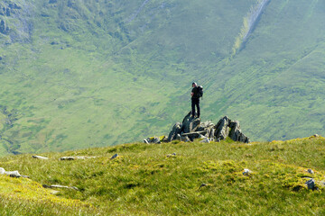 A distant hiker checking position while taking in the views of T