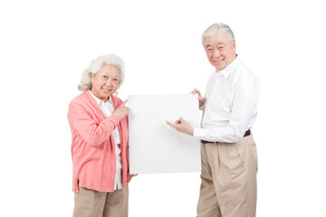 An old senior couple holding white board 