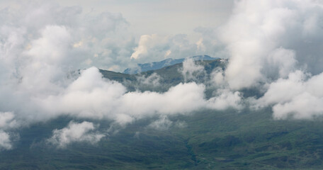White fluffy clouds over the Scottish mountains from above Loch Tay in the Scottish Highlands, UK.