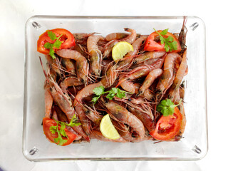 Fresh Rose Shrimp or Pink Shrimp decorated with vegetables and fruits on a glass bowl.Selective focus.