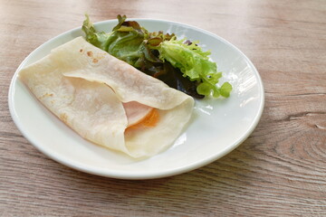 berrito stuffed slice ham pork with cheese and sauce eat couple fresh vegetable on plate