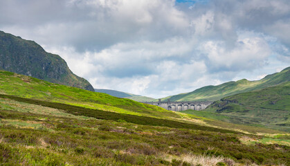 Fototapeta premium The dam wall and towers of Lochan na Lairige reservoir near Loch Tay in the Scottish Highlands, UK.
