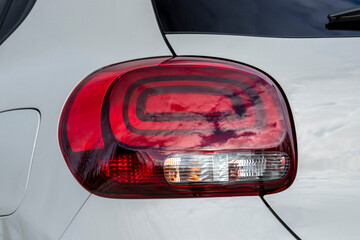 Close-up  car rear tail-lamp with a brakelight stop signal.