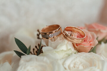 wedding rings close up on bouquet rose.