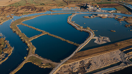 Aerial view on open pit mine of sand, hummus and coal, flooded with water