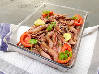Fresh Rose Shrimp or Pink Shrimp decorated with vegetables and fruits on a glass bowl.Selective focus.