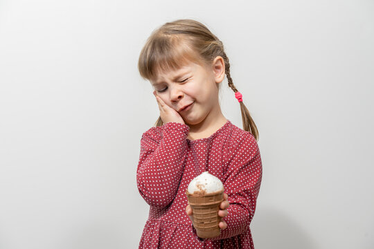 child has a toothache while eating ice cream. sensitivity of teeth to cold
