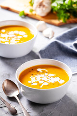 Bowls of homemade organic soup with carrots and potato