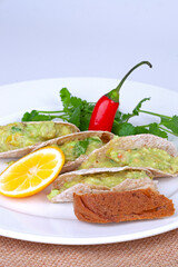  a mexican tacos with avocado on the table