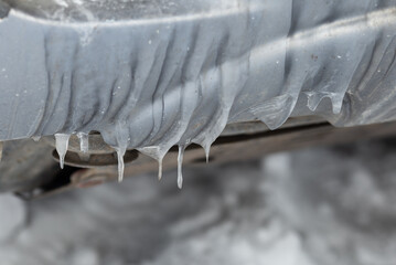 Icicles on the car in winter in Siberia