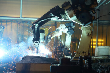 Production  automate wireless Robot arm in smart factory background. Mixed media of welding robot in the automotive parts industry