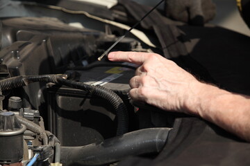 hand of a mechanic at work in his garage or car repair service or auto store, business, maintenance and people concept