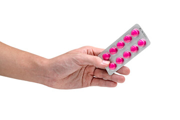 Hand holding blister pack of pink tablets pill isolated on white background