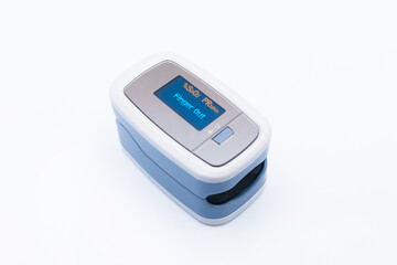 Modern fingertip pulse oximeter on white background, closeup