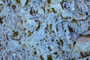 Badly stained texture on the snowy road 