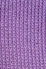 Violet knitted fabric texture background. Top view. Copy, empty space for text