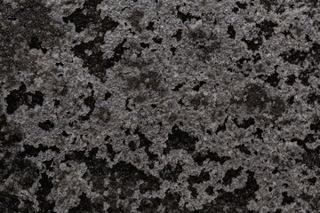 Badly stained texture on the snowy road 