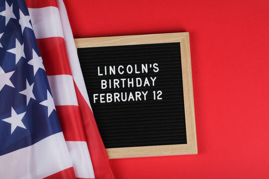 black letter board with text Lincoln's Birthday and American flag on red background. - Powered by Adobe