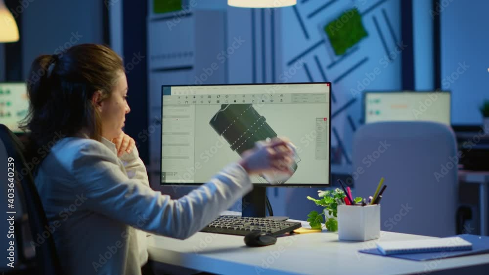 Poster woman engineer working late at night on a 3d model of industrial turbine drinking coffee in front of