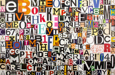 Colorful abstract collage from clippings with newspaper magazine letters and numbers. Alphabet letters cutting from paper magazine background.