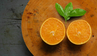 Orange fruit cut in half on a holder, beautiful and delicious.