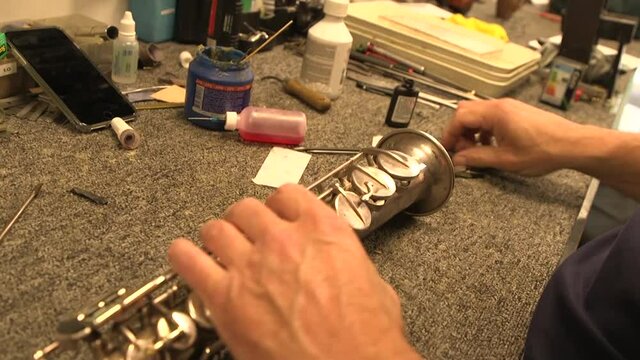 Close up of repairing a soprano saxophone