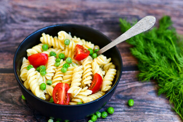Home made vegetarian fusilli  pea  pasta with parmesan cheese and fresh dill  . Healty vegetarian meal